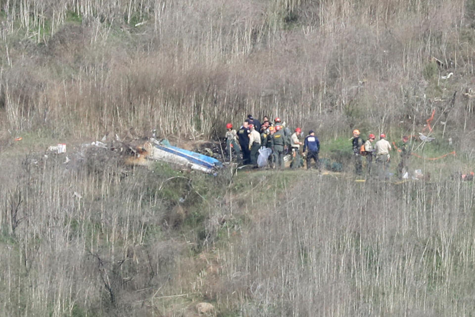 Emergency personnel work at the helicopter crash site that claimed the life of former NBA great Kobe Bryant, his daughter Gianna, 13, and seven others last month in Calabasas, California.