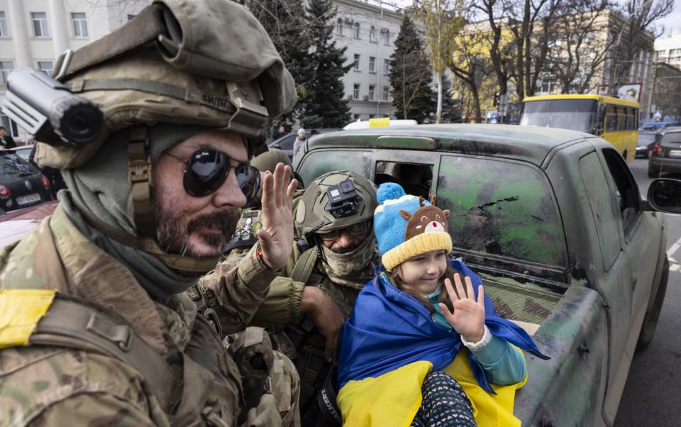 Ukranian military pose with children at Liberty Square as Kherson continues to celebrate their liberation from Russia - Paula Bronstein /Getty Images