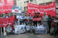 Syrians demonstrate in Idlib, in northwestern Syria, to show solidarity with the civilians of the northern city of Aleppo