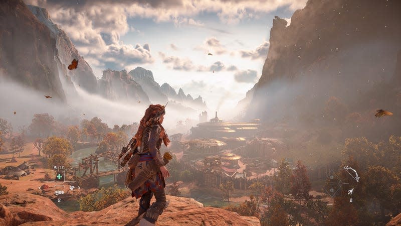 Aloy looks out at a settlement early on in the PS4 version of Horizon Forbidden West. 