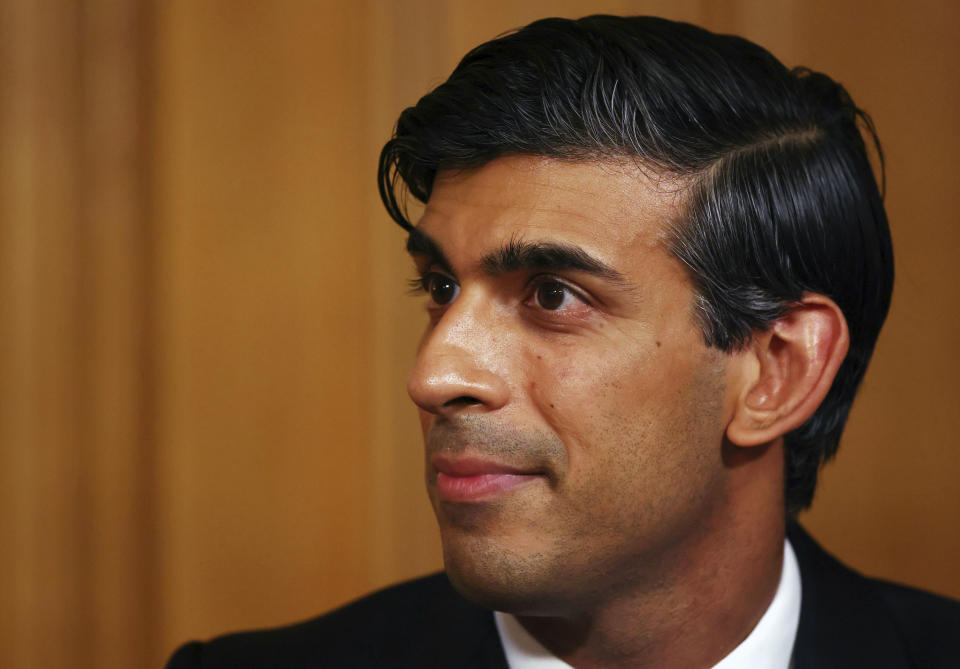 Britain's Chancellor of the Exchequer Rishi Sunak, listens, during a coronavirus briefing, in Downing Street, London, Thursday, Oct. 22, 2020. (Henry Nicholls/Pool Photo via AP)