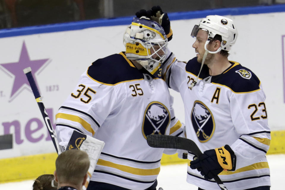 FILE - In this Nov. 24, 2019, file photo, Buffalo Sabres goaltender Linus Ullmark (35) is congratulated by center Sam Reinhart (23) after the Sabres defeated the Florida Panthers 5-2 in an NHL hockey game in Sunrise, Fla. On Sunday, Oct 25, 2020, Buffalo signed Reinhart to a one-year, $5.2 million contract, and Ullmark to a one-year $2.6 million deal. (AP Photo/Lynne Sladky, File)