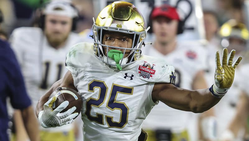 Notre Dame running back Chris Tyree (25) runs the ball during a game against South Carolina on Friday, Dec. 30, 2022, in Jacksonville, Fla. Notre Dame recently became one of six new members of the Association of American Universities.