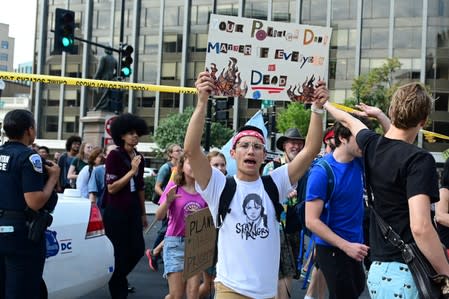 Climate change activists march through police tape in Washington