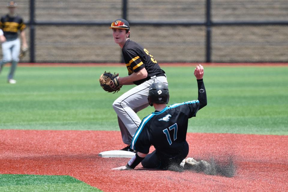 Woodford County's Taylor Penn (35) tags out North OldhamÕs Ryan Julich and looks to first during action of their Eigth Region Championship baseball game, Sunday, May 29 2022 in Louisville Ky. Woodford County won 7-2, and will now play for the state championship.