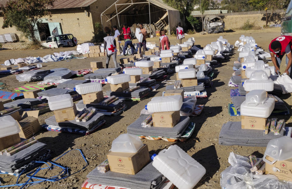 Ethiopian Red Cross Society (ERCS) and International Committee of the Red Cross (ICRC) staff and volunteers arrange essential household and other relief items to be distributed to internally displaced people sheltering in Mekele, the regional capital of the Tigray region of northern Ethiopia Monday, Jan. 18, 2021. Rare witness accounts are illuminating the shadowy conflict in Tigray, which is largely cut off from the outside world as fighting enters a fourth month in a region of 6 million people. (International Committee of the Red Cross via AP)