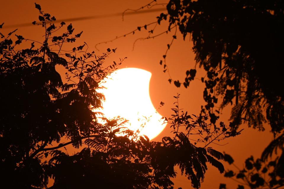 The moon partially obscures the sun during a partial solar eclipse visible from Hyderabad on Oct. 25, 2022.