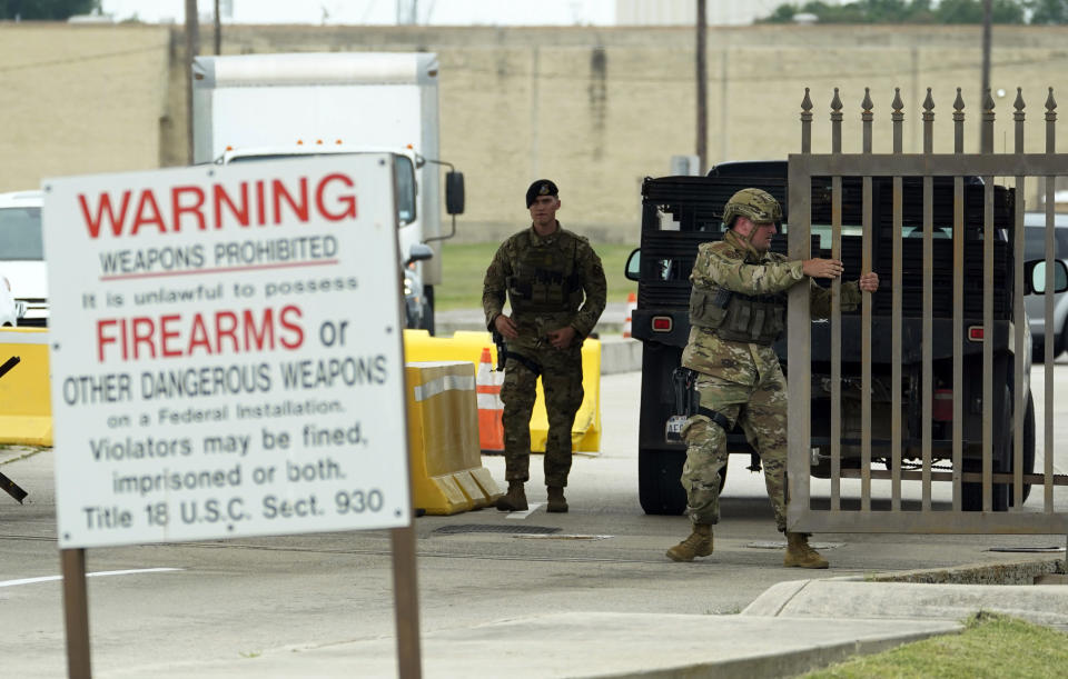 Military police close a gate at JBSA-Lackland Air Force Base gate, Wednesday, June 9, 2021, in San Antonio. The Air Force was put on lockdown as police and military officials say they searched for two people suspected of shooting into the base from outside. (AP Photo/Eric Gay)