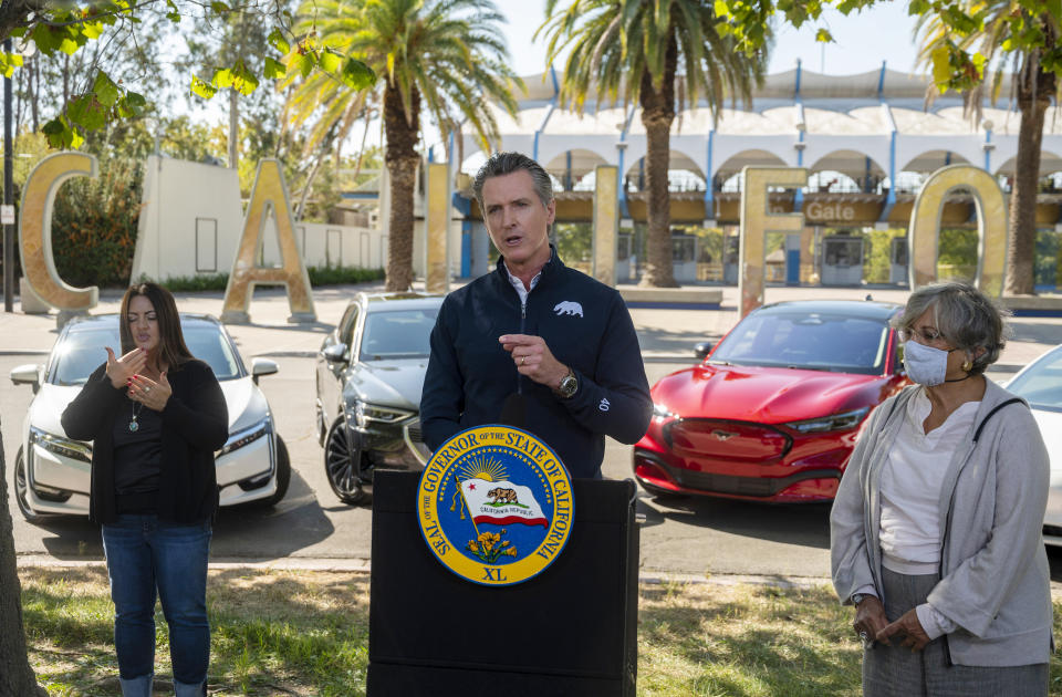 California Gov. Gavin Newsom speaks at a press conference on Wednesday, Sept. 23, 2020, at Cal Expo in Sacramento where he announced an executive order requiring the sale of all new passenger vehicles to be zero-emission by 2035, a move the governor says would achieve a significant reduction in greenhouse gas emissions. California would be the first state with such a rule, though Germany and France are among 15 other countries that have a similar requirement. (Daniel Kim/The Sacramento Bee via AP, Pool)