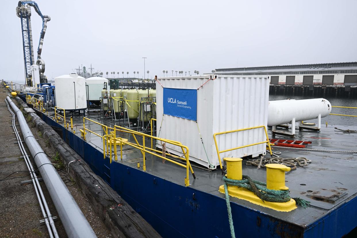 Equipment on a barge for UCLA's SeaChange climate change carbon removal project at the Port of Los Angeles in San Pedro, California on April 12, 2023. - Floating in the port of Los Angeles, a strange-looking barge covered with pipes and tanks contains a concept that scientists hope to make waves: a new way to use the ocean as a vast carbon dioxide sponge to tackle global warming.
Scientists from University of California Los Angeles (UCLA) have been working for two years on SeaChange -- an ambitious project that could one day boost the amount of CO2, a major greenhouse gas, that can be absorbed by our seas. (Photo by Patrick T. Fallon / AFP) (Photo by PATRICK T. FALLON/AFP via Getty Images)