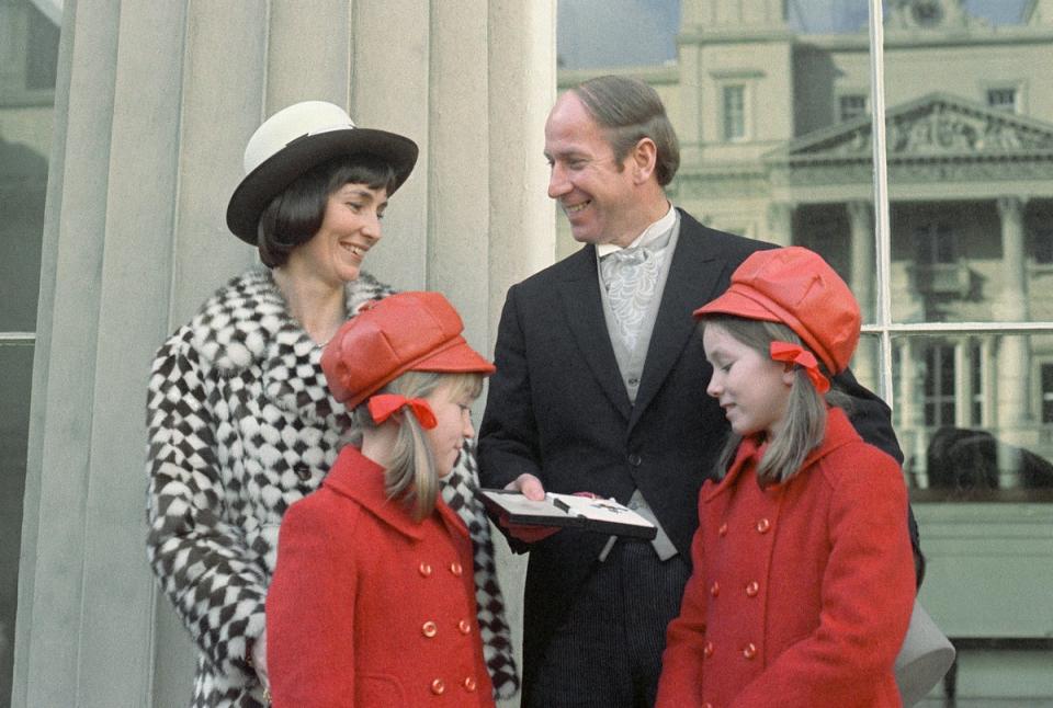 Collecting his CBE at Buckingham Palace in 1974, with his wife Norma and daughters Suzanne and Andrea (AP)