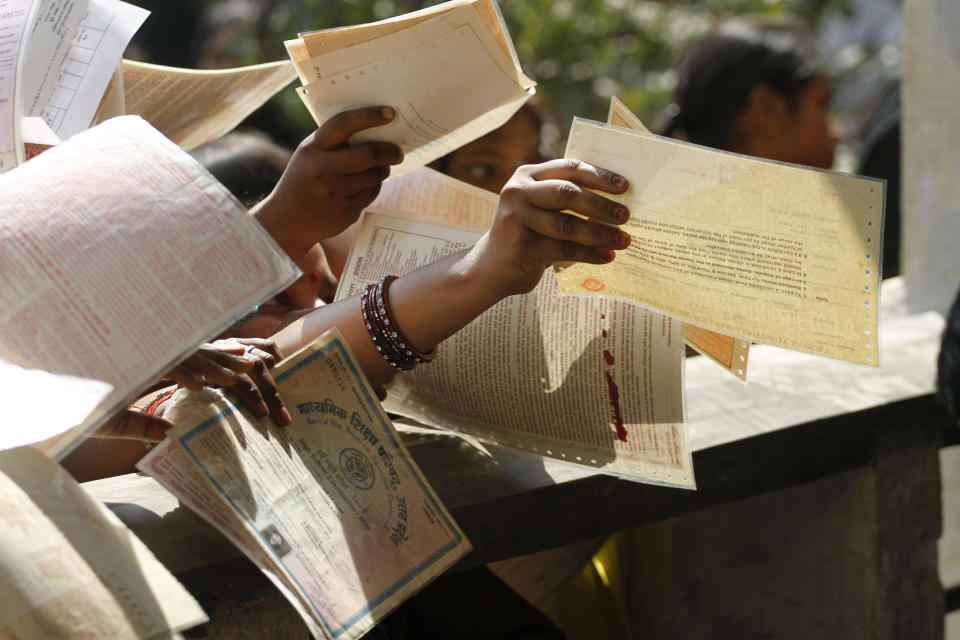 Unemployed Indian women hold out forms as they crowd at the Employment Exchange Office (EEO) in Allahabad, India, Wednesday, Feb. 29, 2012. The state government office offers job placement to the registered unemployed applicants when positions become available.(AP Photo/Rajesh Kumar Singh)