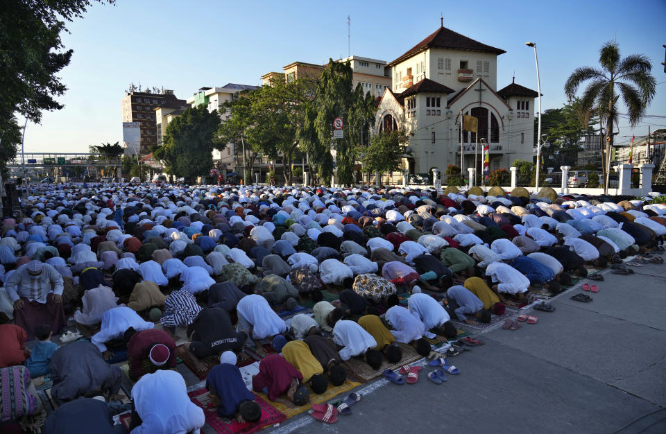 Muslims perform a morning prayer marking the Eid al-Adha holiday on a street in Jakarta, Indonesia, Sunday, July 10, 2022. Muslims around the world will celebrate Eid al-Adha, or Festival of Sacrifice, slaughtering sheep, goats, cows and camels to commemorate Prophet Abraham's readiness to sacrifice his son Ismail on God's command. (AP Photo/Tatan Syuflana)