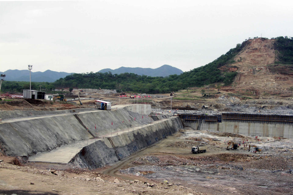 FILE - In this June 28, 2013 file photo, construction work takes place, at the site of the Grand Ethiopian Renaissance Dam near Assosa, Ethiopia. Mohamed Hamdan Dagalo, a top Sudanese general on Sunday, March 15, 2020, said his country would mediate a deal on an escalating dispute between Ethiopia and Egypt over Ethiopia's controversial dam on the Nile River. Tensions are rising because of the impasse between Ethiopia and Egypt over the $4.6 billion Grand Ethiopian Renaissance Dam. The project is around 71% complete and promises to provide much-needed electricity to Ethiopia’s 100 million people. (AP Photo/Elias Asmare, File)