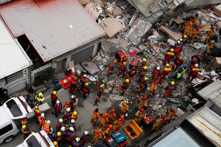 Rescue personnel work at a collapsed building after an earthquake hit Hualien, Taiwan February 9, 2018. REUTERS/Tyrone Siu