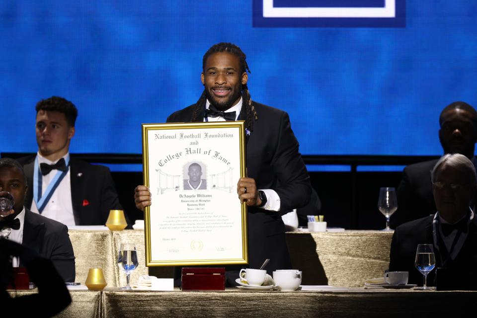 Former Memphis football running back DeAngelo Williams smiles as he's inducted into the College Football Hall of Fame.