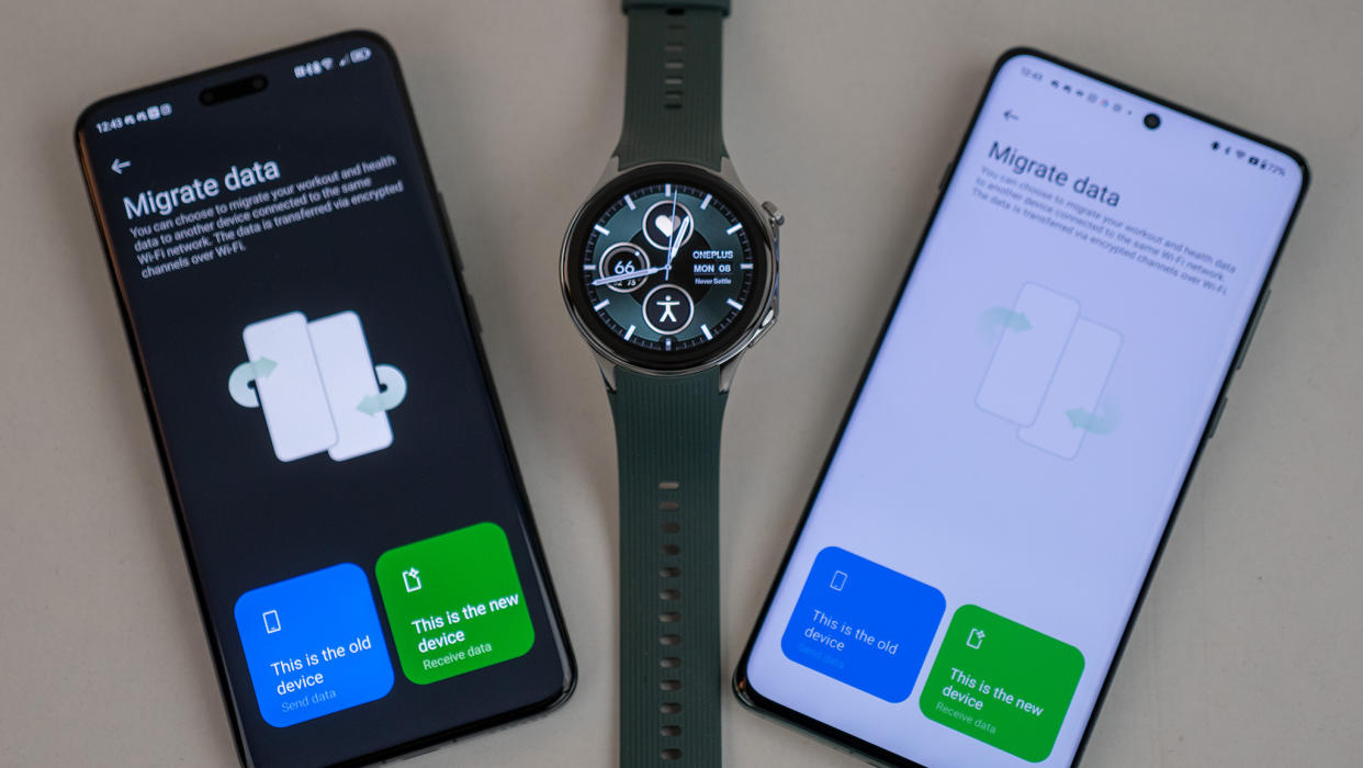  The OnePlus Watch 2 sitting in-between two Android phones for an OHealth data transfer, for showing how to transfer Wear OS watch to new phone. 