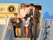 <p>Ivanka Trump departed Air Force One with her husband, Jared Kushner, and their 3 children at Palm Beach International airport in in West Palm Beach, Fla. She was wearing a sleek ivory coat, shades, and sandals. (Photo: AP Images) </p>