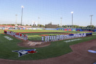 The Los Angeles Angels and Toronto Blue Jays line up for the anthems prior to a baseball game Thursday, April 8, 2021, in Dunedin, Fla. (AP Photo/Mike Carlson)