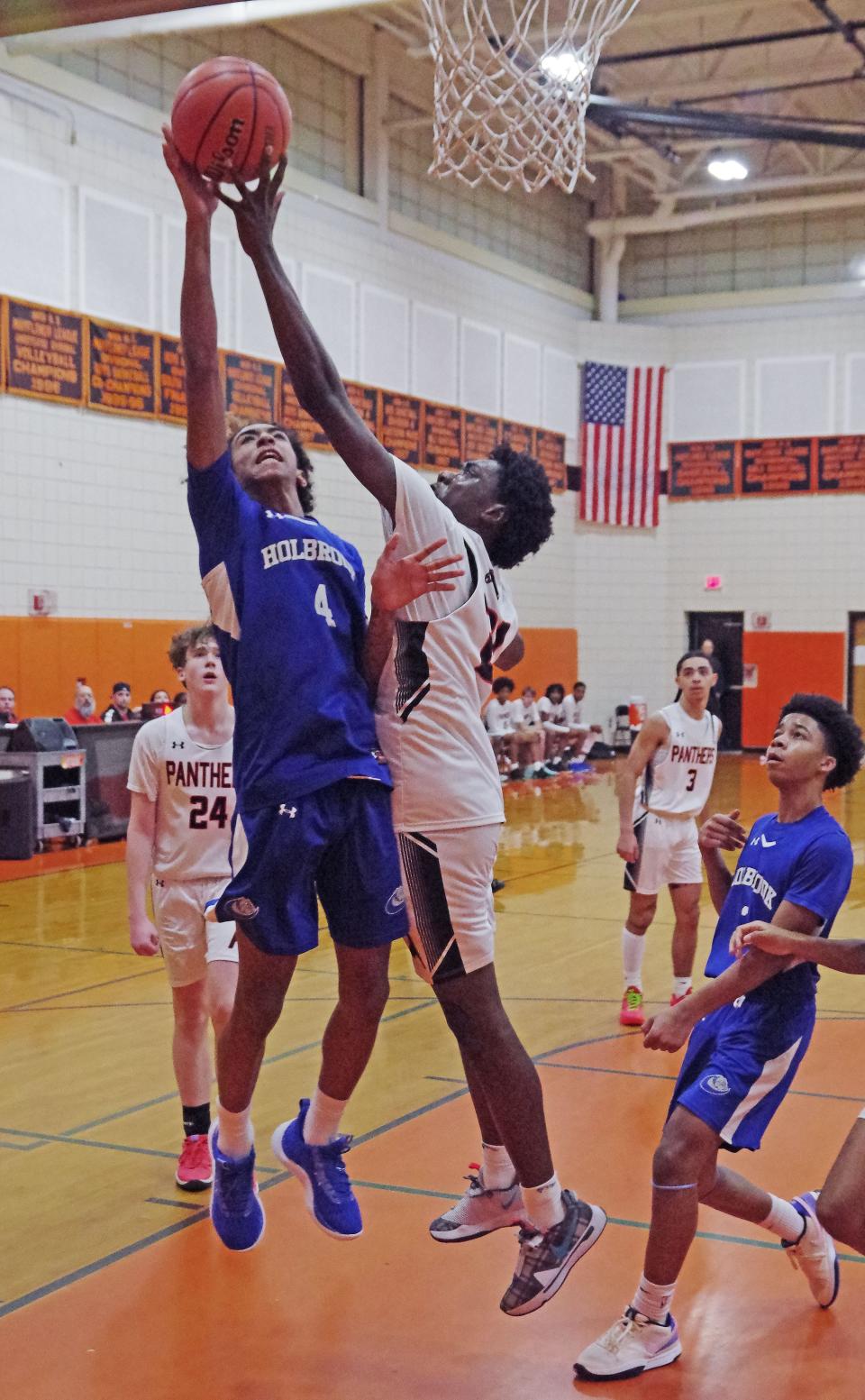 Holbrook's Jalik Fernandes goes to the basket for a shot but is rejected by Avon's Josiah Guerrier, who later got the last second game winning shot to beat the Bulldogs 72-70 on OT on Wednesday, Jan. 10, 2024.