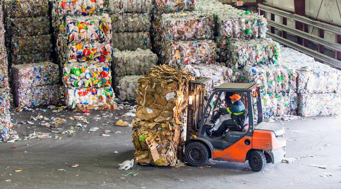 Bales of cardboard are loaded onto trucks at the Sonoco Recycling facility on Wednesday, Mar. 7, 2018, in Raleigh, NC.