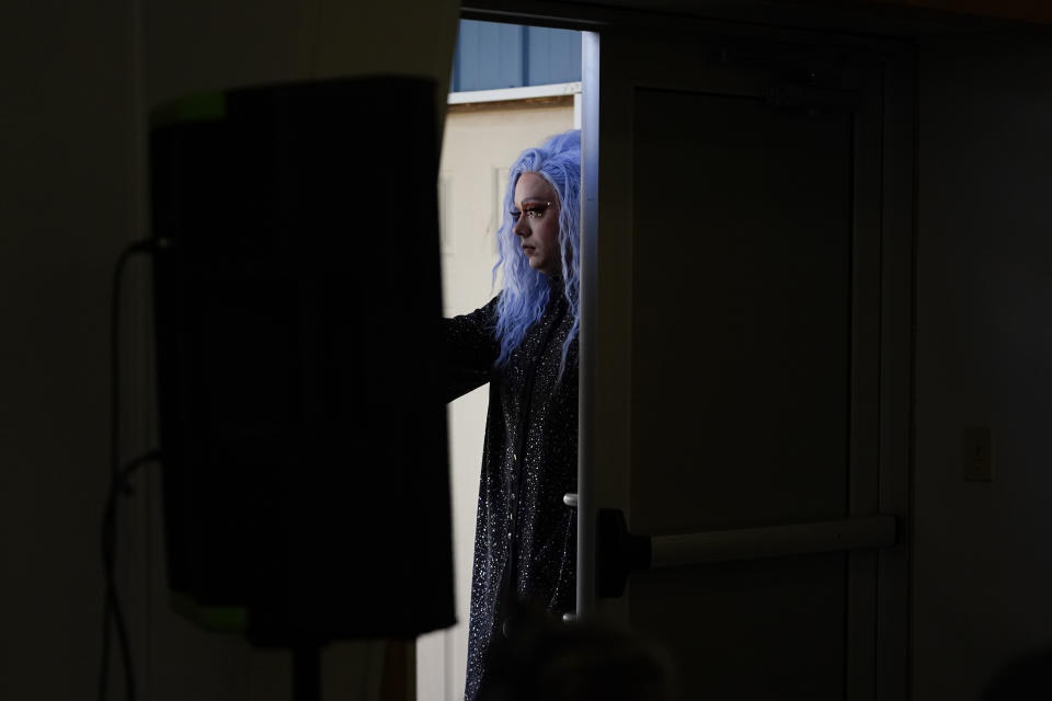 Drag queen Trixy Valentine, aka Jacob Kelley, pauses before entering to perform her drag story mix at a "Drag Bingo" fundraiser at the Nescopeck Township Volunteer Fire Company Social Hall, in Nescopeck, Pa., Saturday, March 18, 2023, to raise money for a new roof for the Berwick Theater and Center for Community Arts, in Berwick, Pa. (AP Photo/Carolyn Kaster)