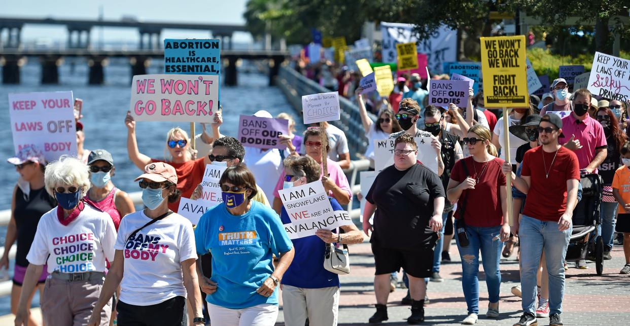 Abortion rights demonstrators march along the Bradenton Riverwalk en route to the steps of the Manatee County Courthouse in October 2021. The Bradenton March, led by Women’s Voices of Southwest Florida, was one of hundreds nationwide organized to show mass opposition to a new Texas abortion law and similar legislation in other states.