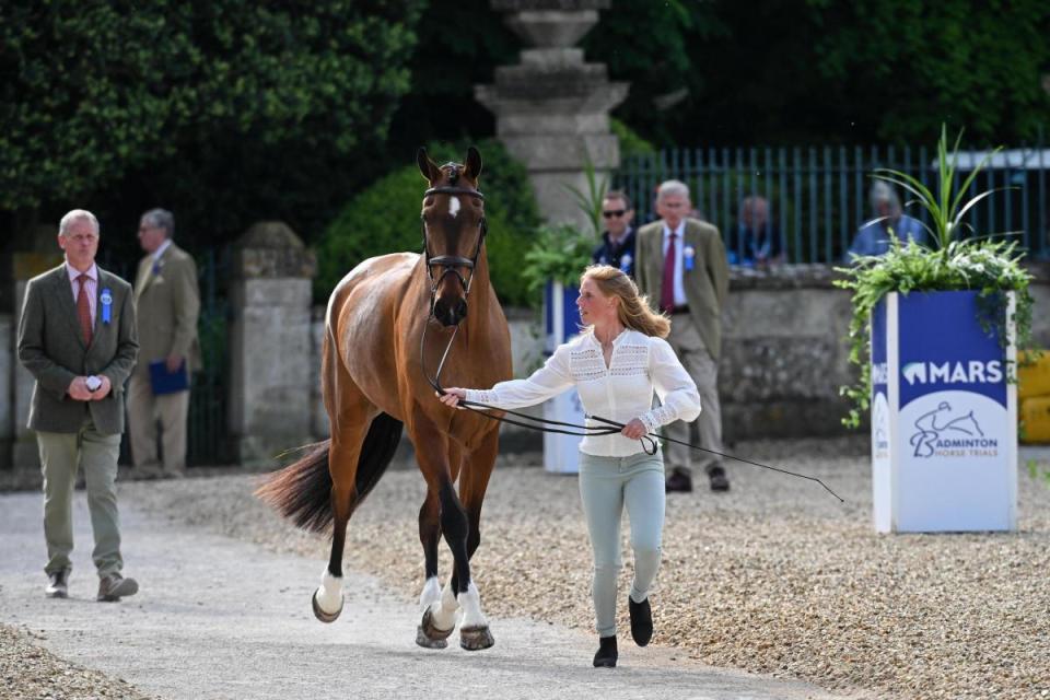 Ros Canter, the 2023 Badminton winner, trots up Izilot DHI at the first horse inspection in front of Badminton House <i>(Image: Peter Nixon/Badminton.)</i>