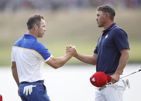 Golf - 2018 Ryder Cup at Le Golf National - Guyancourt, France - September 30, 2018 - Team Europe's Paul Casey shakes hands with Team USA's Brooks Koepka during the Singles REUTERS/Carl Recine