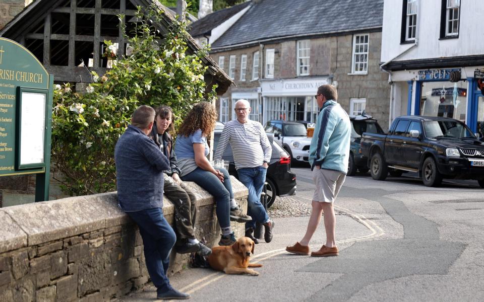 Locals enjoying an evening drink outside the St Agnes Hotel - John Lawrence for The Telegraph