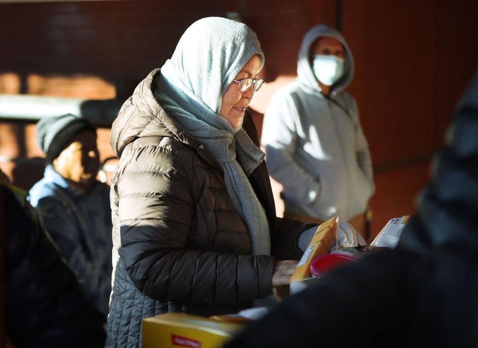 Zakiel Zavari receives food as Mosaic Inter-Faith Ministries hands out Thanksgiving meals in Salt Lake City on Tuesday, Nov. 21, 2023. | Jeffrey D. Allred, Deseret News