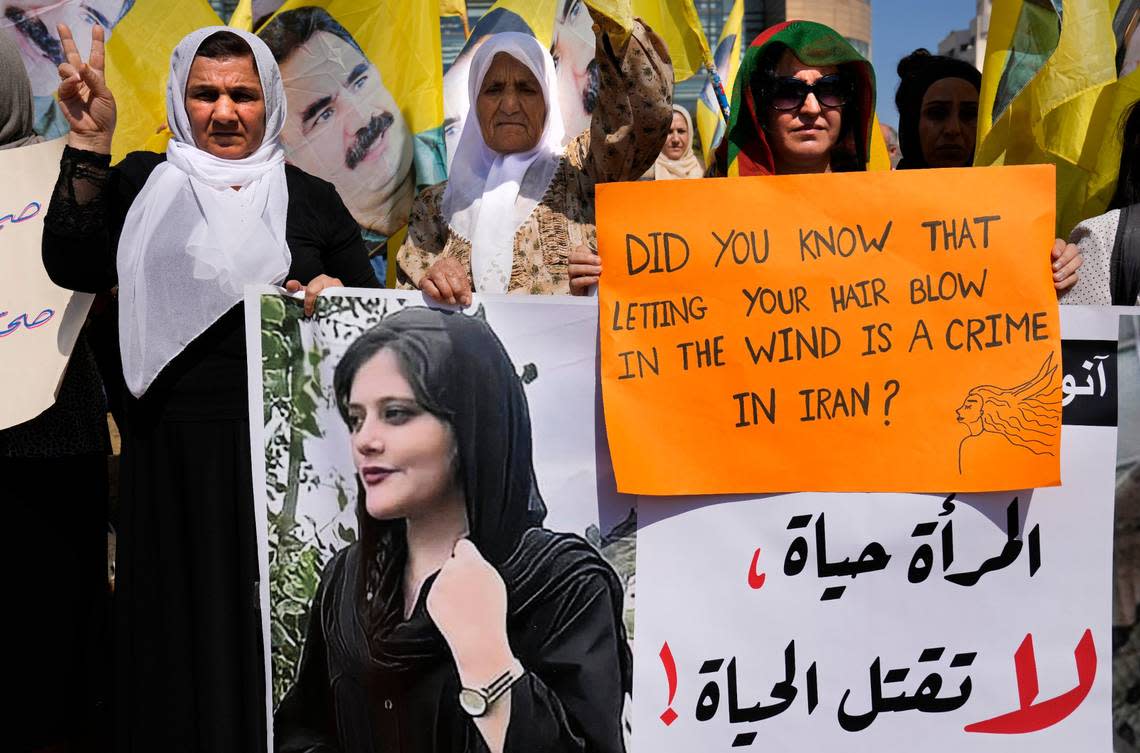 Kurdish supporters of the Kurdistan Workers’ Party, known as PKK, hold a portrait of Iranian Mahsa Amini, with Arabic placard that reads, “Women are life, don’t kill the life,” during a protest against her death in Iran, in Beirut, Lebanon, Sunday, Oct. 9, 2022. Amini, 22, who died in Iran while in police custody, was arrested by Iran’s morality police for allegedly violating its strictly enforced dress code. (AP Photo/Hussein Malla)