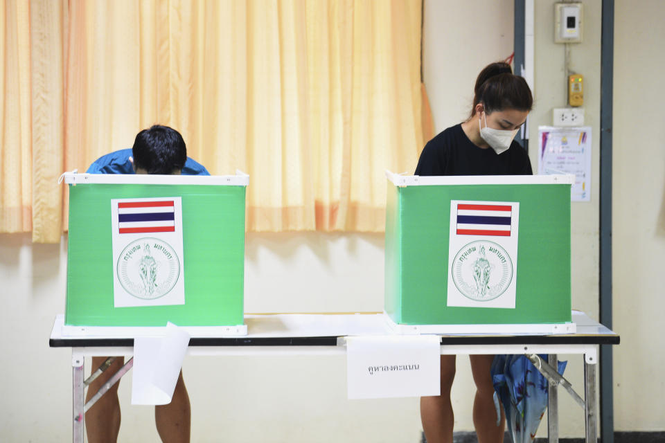Thai people cast their ballots in Bangkok's gubernatorial election at a polling station in Bangkok, Thailand, Sunday, May 22, 2022. Residents of the Thai capital Bangkok voted Sunday to elect a new governor, in a contest whose results will be seen as a measure of the strength of the government of Prime Minister Prayuth Chan-ocha. (AP Photo/Thanachote Thanawikran)