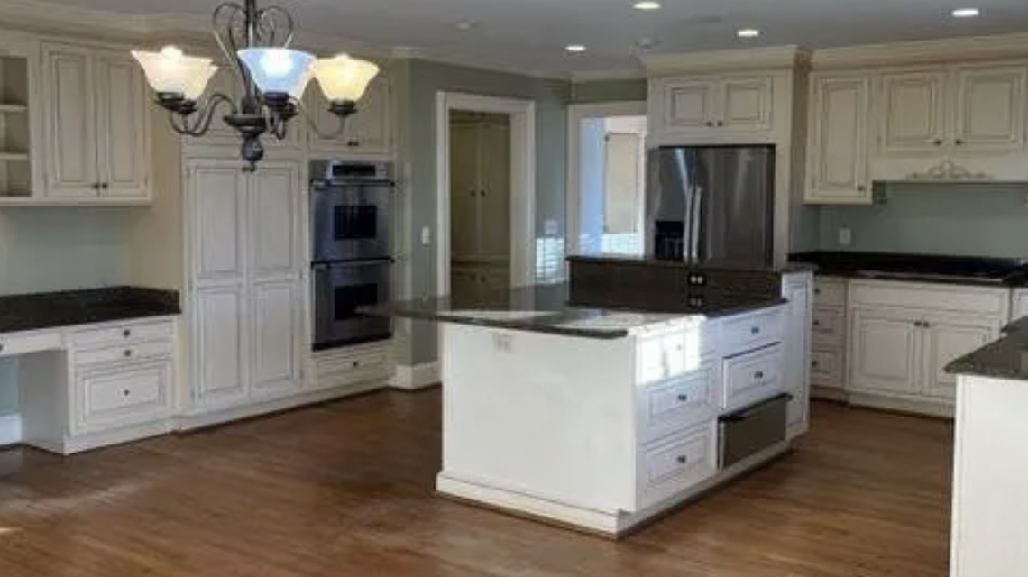 The eat-in kitchen has an island and countertops and backsplash in granite.