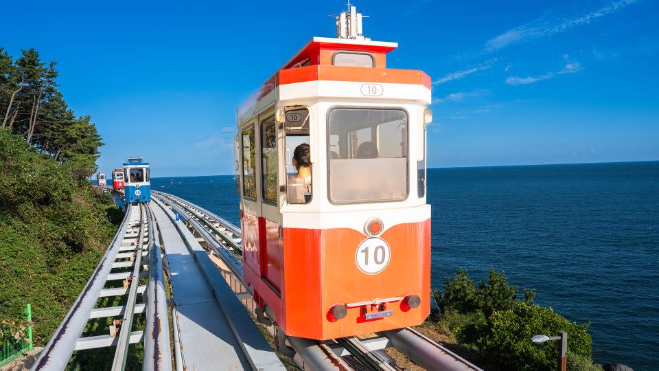 The Haeundae Sky Capsule cruises along the edge of Dalmaji Hill. - Jackyenjoyphotography/Moment RF/Getty Images