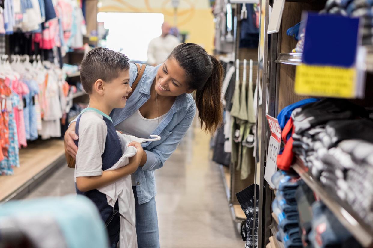 mom shops for school clothes with her son