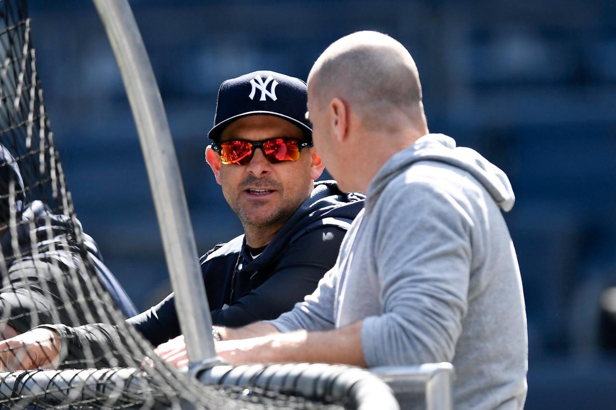 New York Yankees manager Aaron Boone, left, and general manager Brian Cashman talk during the team workout on Thursday, Oct. 10, 2019, in the Bronx.