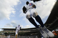 Chicago Cubs' Jason Heyward right, jumps on the field from the dugout while Javier Baez (9) and other teammates run on the field before a baseball game against the Cleveland Indians Tuesday, June 22, 2021, at Wrigley Field in Chicago. (AP Photo/Paul Beaty)