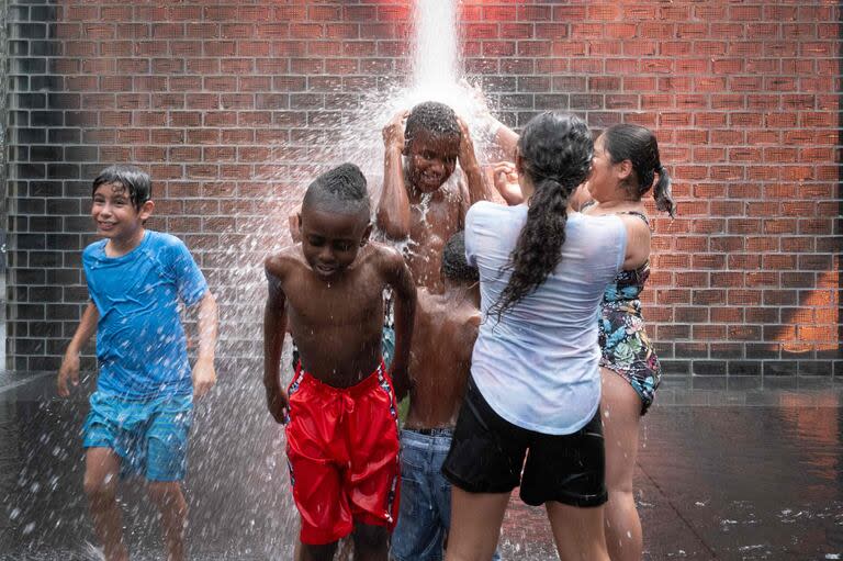 La gente se refresca en la Fuente de la Corona del Parque del Milenio mientras las temperaturas alcanzan un récord de 97 grados Fahrenheit el 17 de junio de 2024 en Chicago, Illinois.