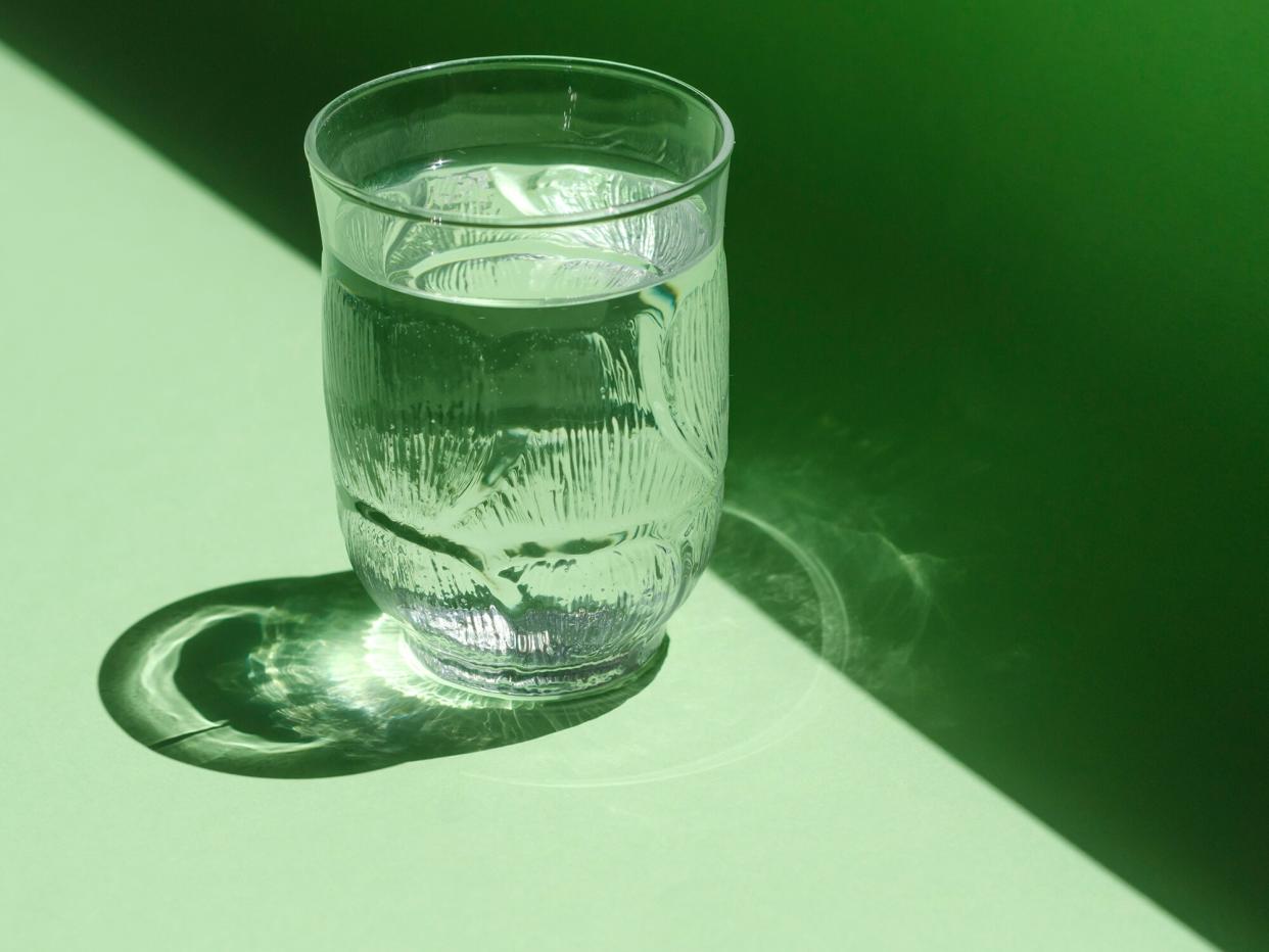 glass of water on a green background