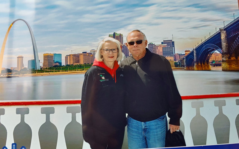 Kay and Gary Powell with the St. Louis Arch behind them.