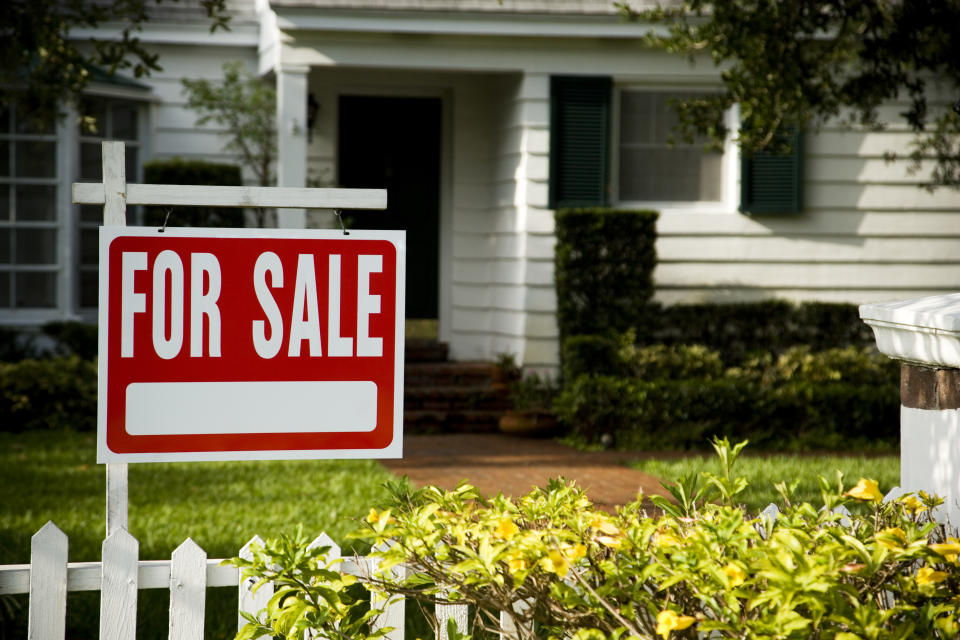 For sale sign outside a family house