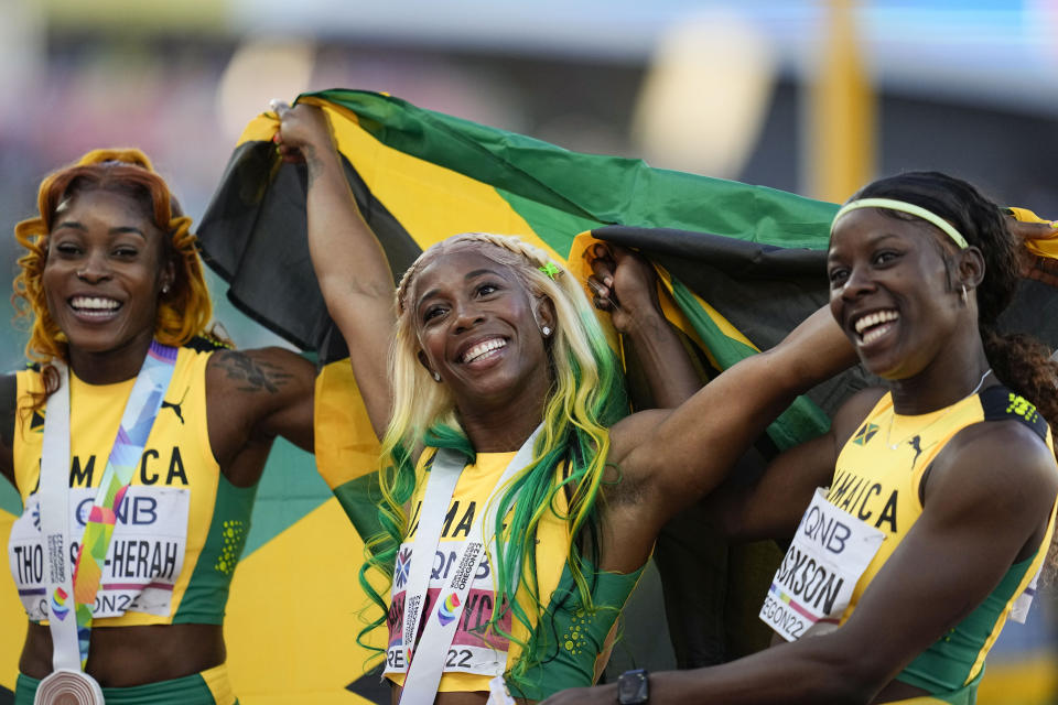 FILE - Shelly-Ann Fraser-Pryce, of Jamaica, center, reacts after winning Gold in the final in the women's 100-meter run with teammates Elaine Thompson-Herah and Shericka Jackson, at the World Athletics Championships on Sunday, July 17, 2022, in Eugene, Ore. Fraser-Pryce said the Paris Games will be her fifth and final Olympics. (AP Photo/Ashley Landis, File)