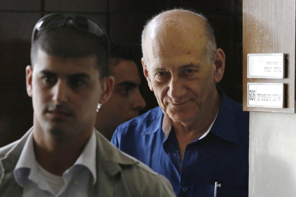 Israel's former Prime Minister Ehud Olmert leaves the Tel Aviv District Court in Israel, Tuesday, May 13, 2014. Olmert was sentenced on Tuesday to six years in prison for his role in wide-ranging bribery case, capping a stunning fall from grace for one of the most powerful men in the country. (AP Photo/Finbarr O'Reilly, Pool)