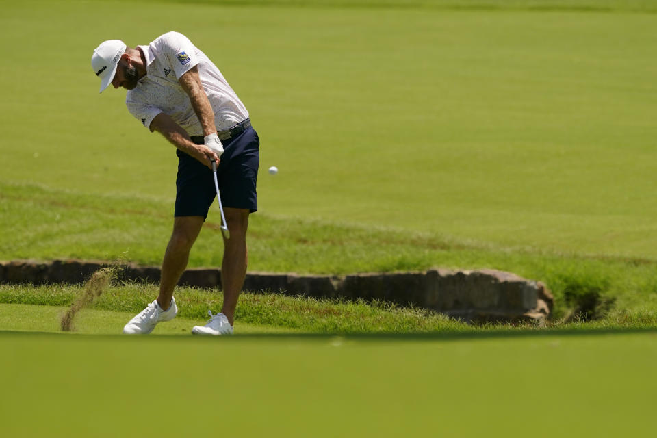 Dustin Johnson hits from the fairway on the second hole during a practice round for the PGA Championship golf tournament, Wednesday, May 18, 2022, in Tulsa, Okla. (AP Photo/Matt York)