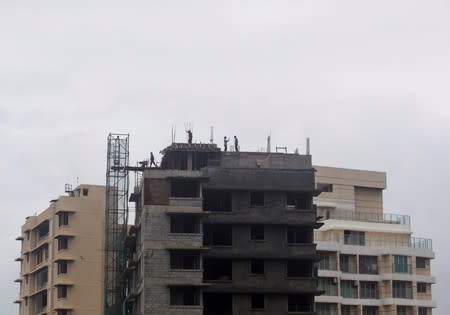 Labourers work at the site of an under construction residential building in Mumbai