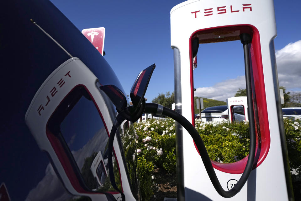 A Tesla vehicle connects with a charging station in Westlake, California on May 10, 2023. (AP Photo/Mark J. Terrill)