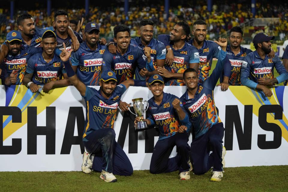 Sri Lankan team members pose with the winner's trophy after defeating Australia by 3-2 in their five match one-day international cricket match series in Colombo, Sri Lanka, Friday, June 24, 2022. (AP Photo/Eranga Jayawardena)