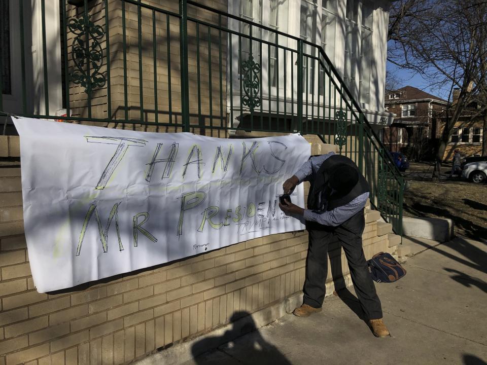 Ziff Sistrunk of Chicago places a sign of support in front of the home of Patti Blagojevich, wife of former Illinois Gov. Rod Blagojevich, in the Ravenswood neighborhood of Chicago Tuesday, Feb. 18, 2020. President Donald Trump commuted the 14-year prison sentence of Blagojevich Tuesday, calling the sentence "ridiculous." (AP Photo/Charles Rex Arbogast)