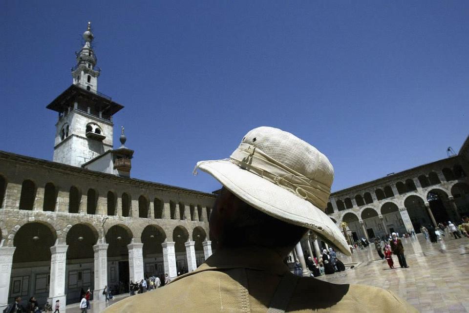 <b>DAMASCUS, SYRIA:</b> A file photo from 2005 shows a German tourist admiring the minaret of the 8th century Umayyad Mosque in Damascus, Syria. After the Arab conquest of Damascus in 634, the mosque was built on the site of a Christian basilica dedicated to John the Baptist also honoured as a prophet, Yahya, by Muslims.
